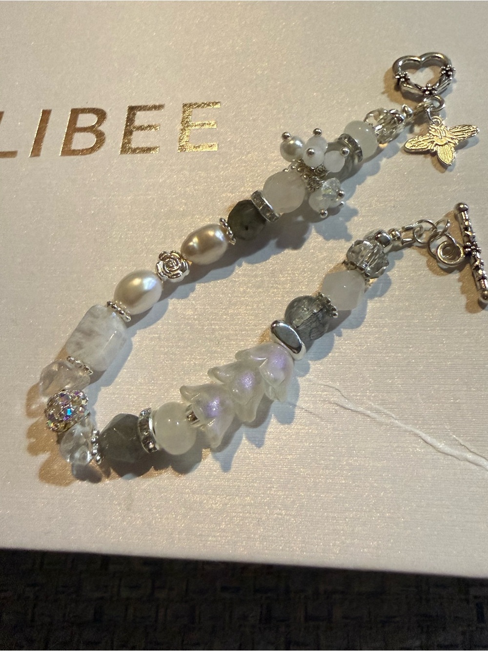 Delicate White and Silver Beaded Bracelet with Floral Charm
